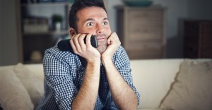 Man watching TV intensely